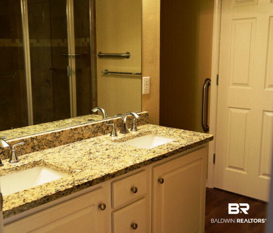 229 Spring Lake Drive Fairhope, AL 36532 - Photo 8 of 21 Master bath has double vanities. With large walk-in tile shower.