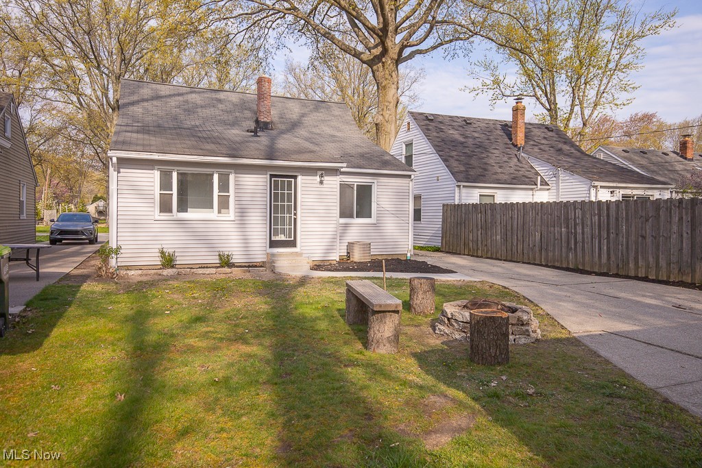 223 Beck Road Avon Lake, OH 44012 - Photo 24 of 29 Rear view of house with fence, a fire pit, a yard, and entry steps