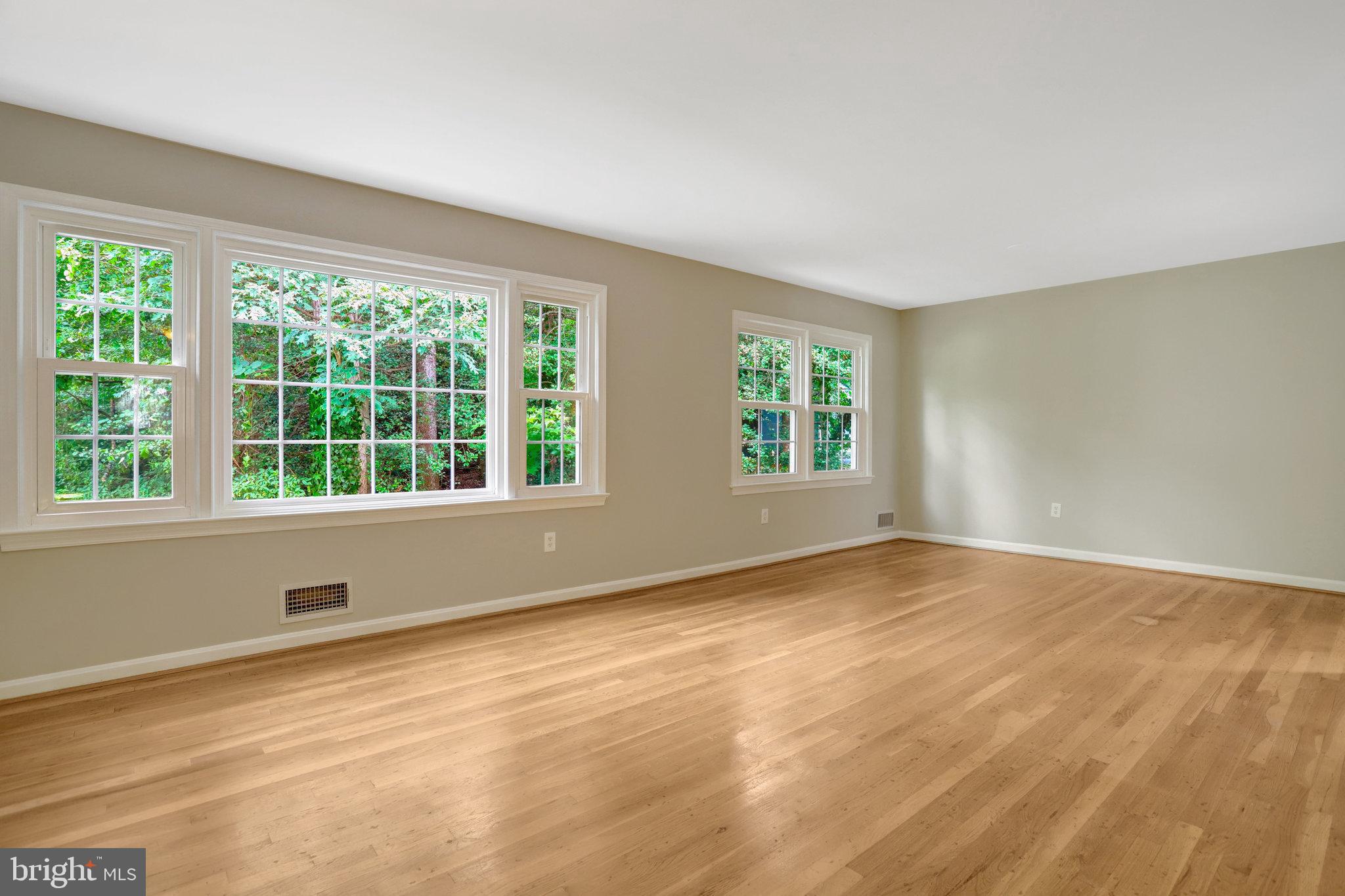 8706 Fox Ridge Road Springfield, VA 22152 - Photo 20 of 76 a view of an empty room with wooden floor and a window