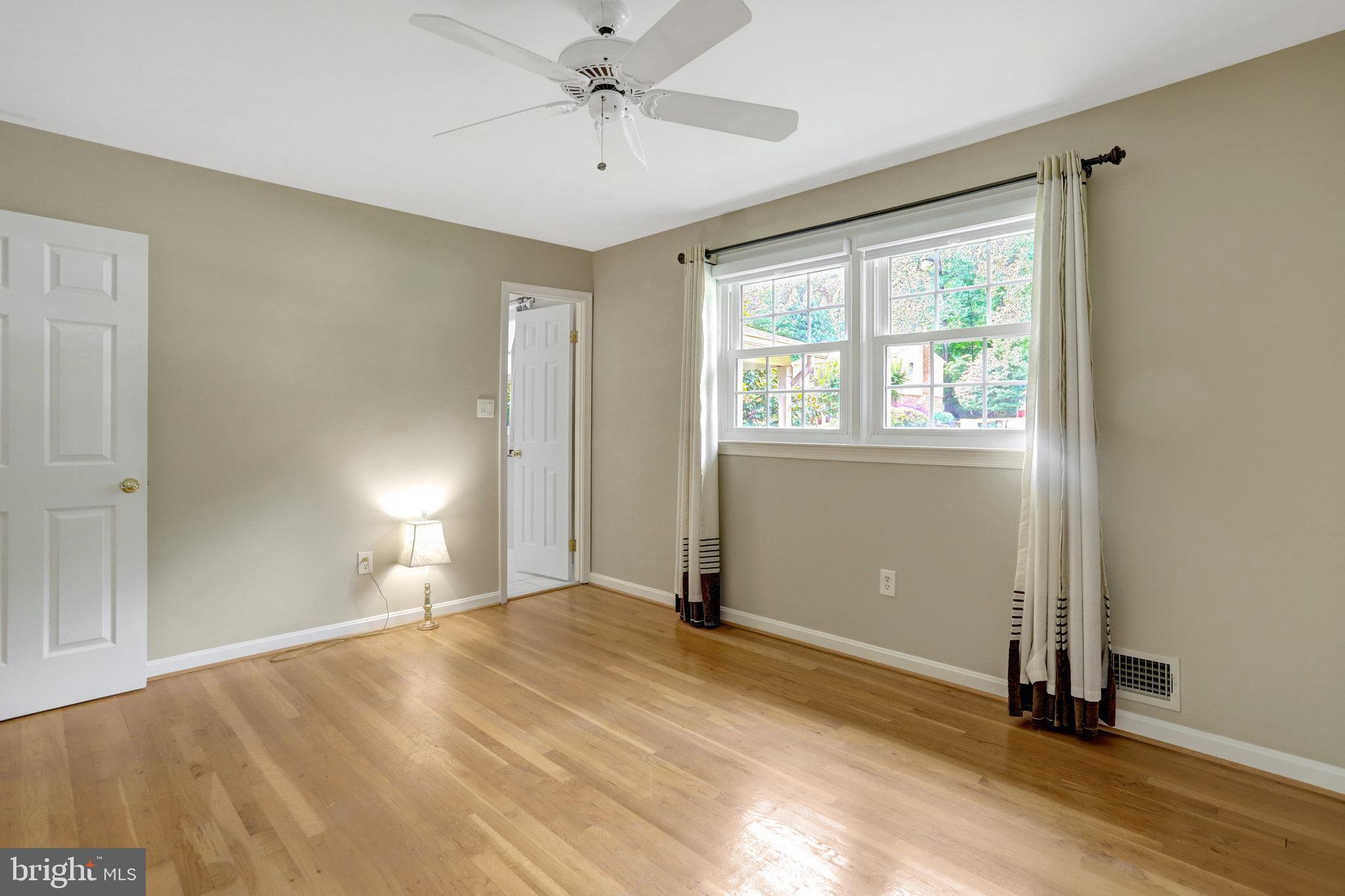 8706 Fox Ridge Road Springfield, VA 22152 - Photo 26 of 76 a view of an empty room with window and wooden floor