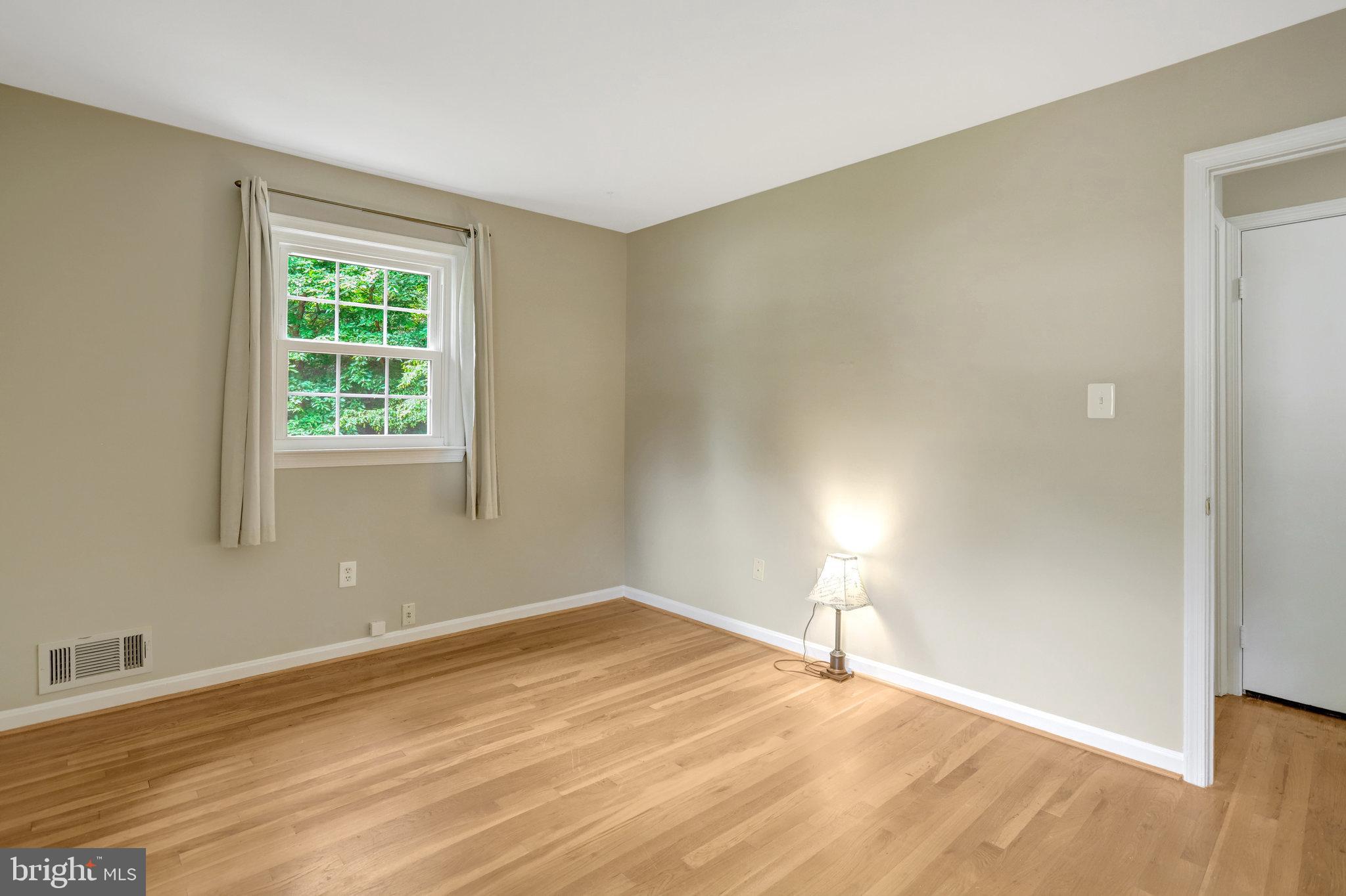 8706 Fox Ridge Road Springfield, VA 22152 - Photo 33 of 76 a view of empty room with wooden floor and fan