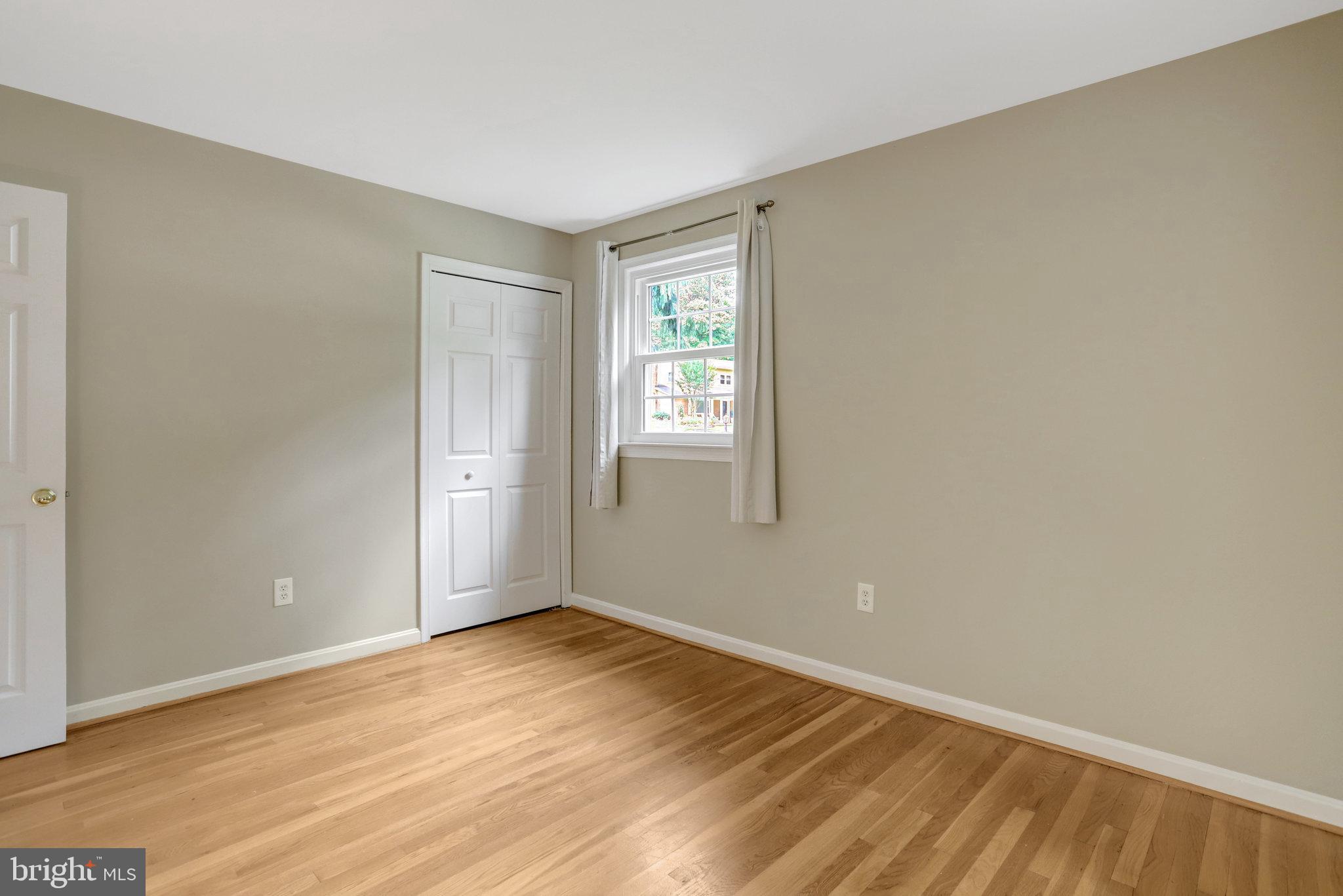 8706 Fox Ridge Road Springfield, VA 22152 - Photo 35 of 76 a view of an empty room with wooden floor and window