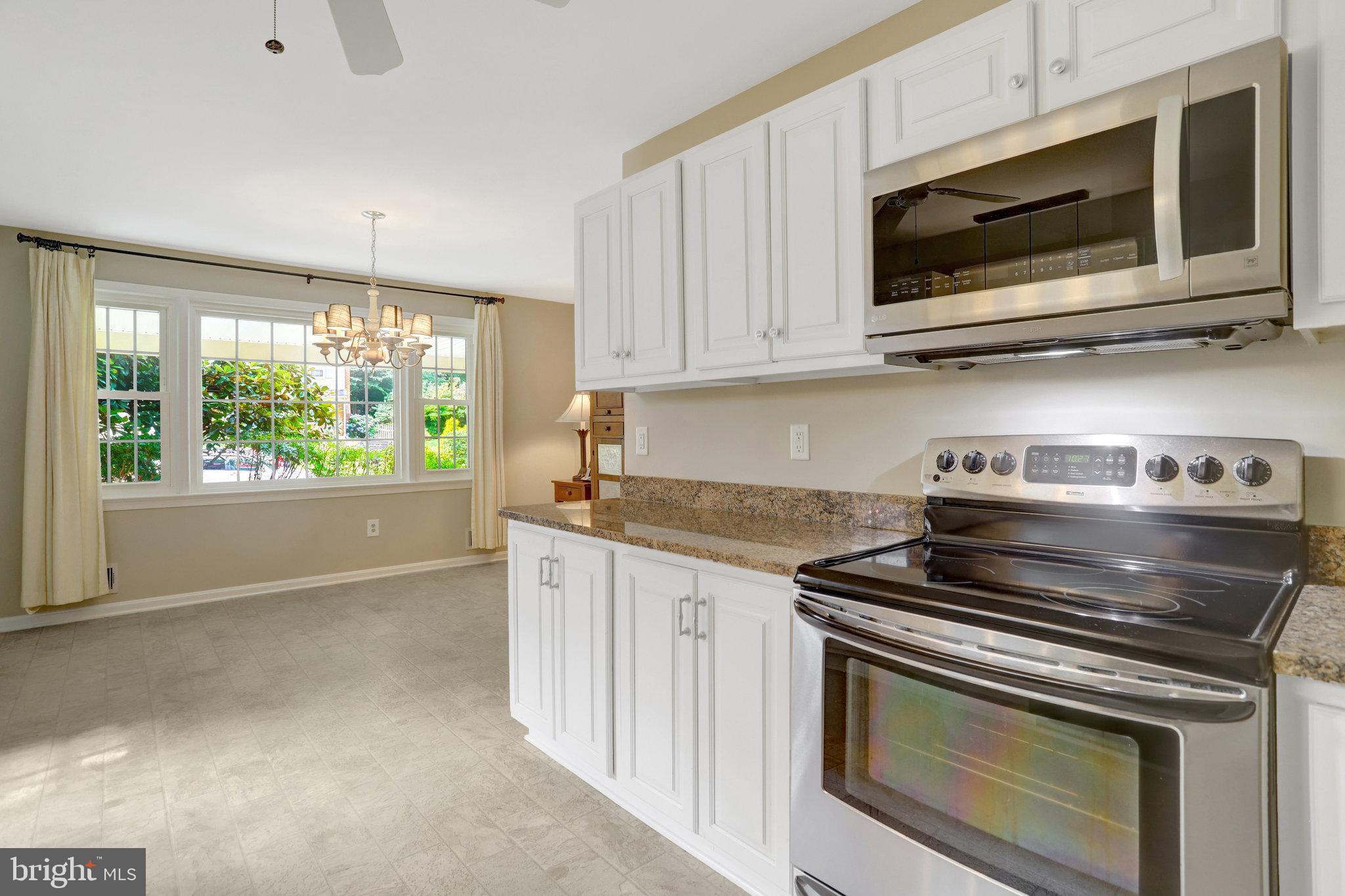 8706 Fox Ridge Road Springfield, VA 22152 - Photo 8 of 76 a kitchen with stainless steel appliances granite countertop a stove microwave and cabinets
