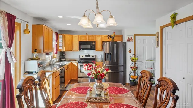 a very nice looking dining room with furniture one side kitchen view
