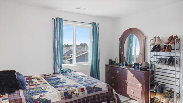 a bedroom with a bed and a dresser