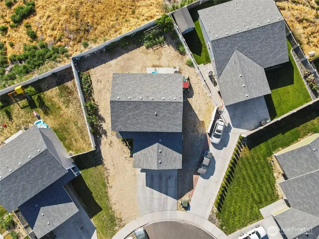 an aerial view of a house with a yard