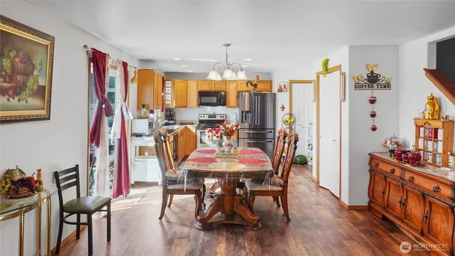 a dining room with furniture and wooden floor