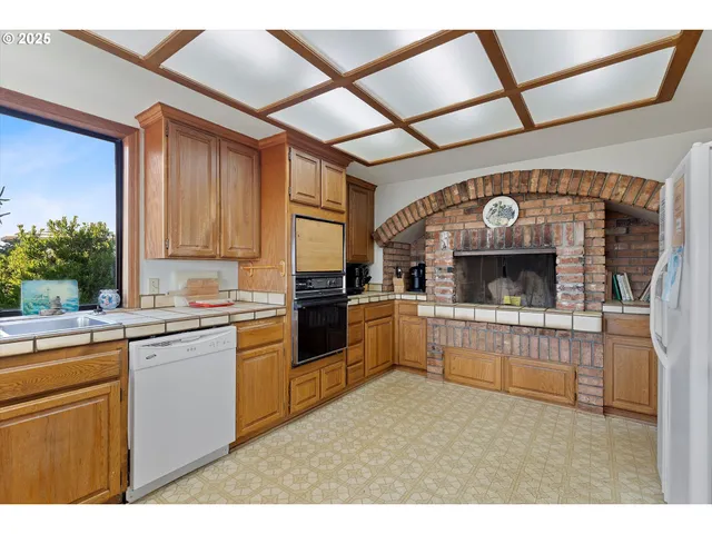 a kitchen with a stove a refrigerator and a sink