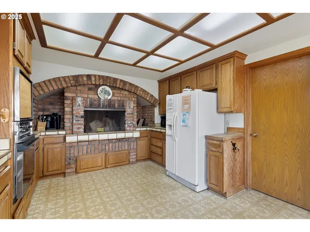 a kitchen with refrigerator and cabinets