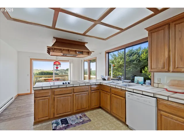 a kitchen with lots of counter top space sink and wooden floor