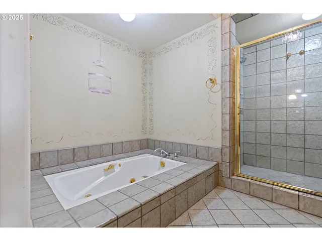 a bedroom with a bed and a lamp on dresser