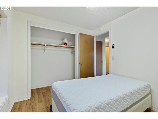 a bedroom with furniture and a wooden floor