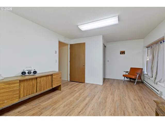 a living room with furniture and a kitchen view