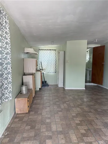 a view of a livingroom with furniture and an empty room