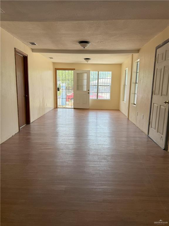 353 East Dicker Road Pharr, TX 78577 - Photo 15 of 32 a view of an empty room with wooden floor and a window