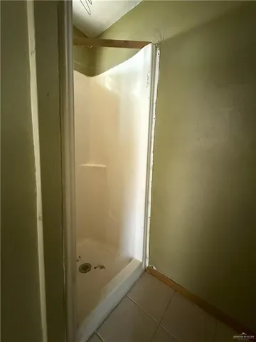 a bathroom with a glass shower door