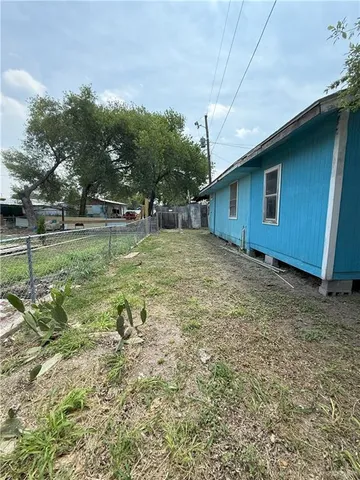 a backyard of a house with table and chairs
