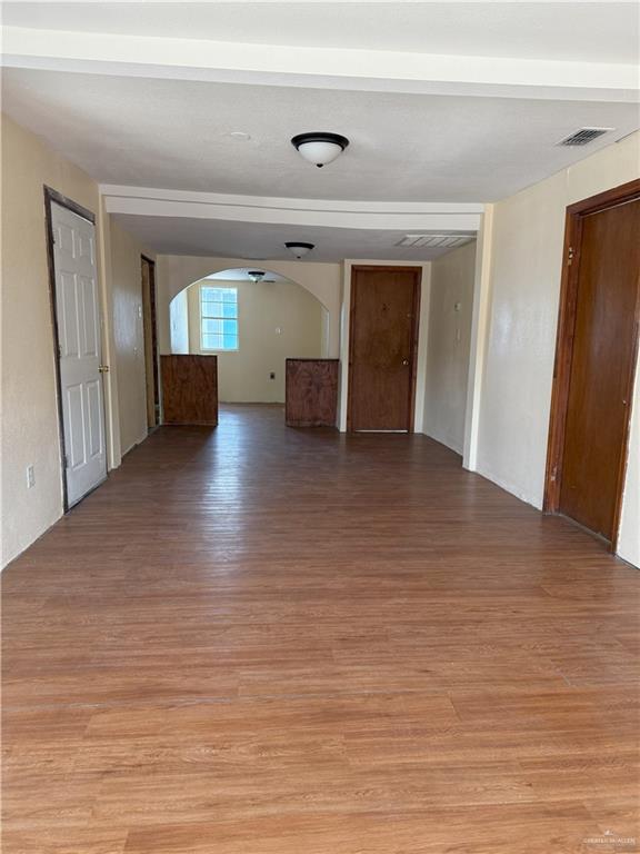 353 East Dicker Road Pharr, TX 78577 - Photo 4 of 32 a view of empty room with wooden floor and fireplace