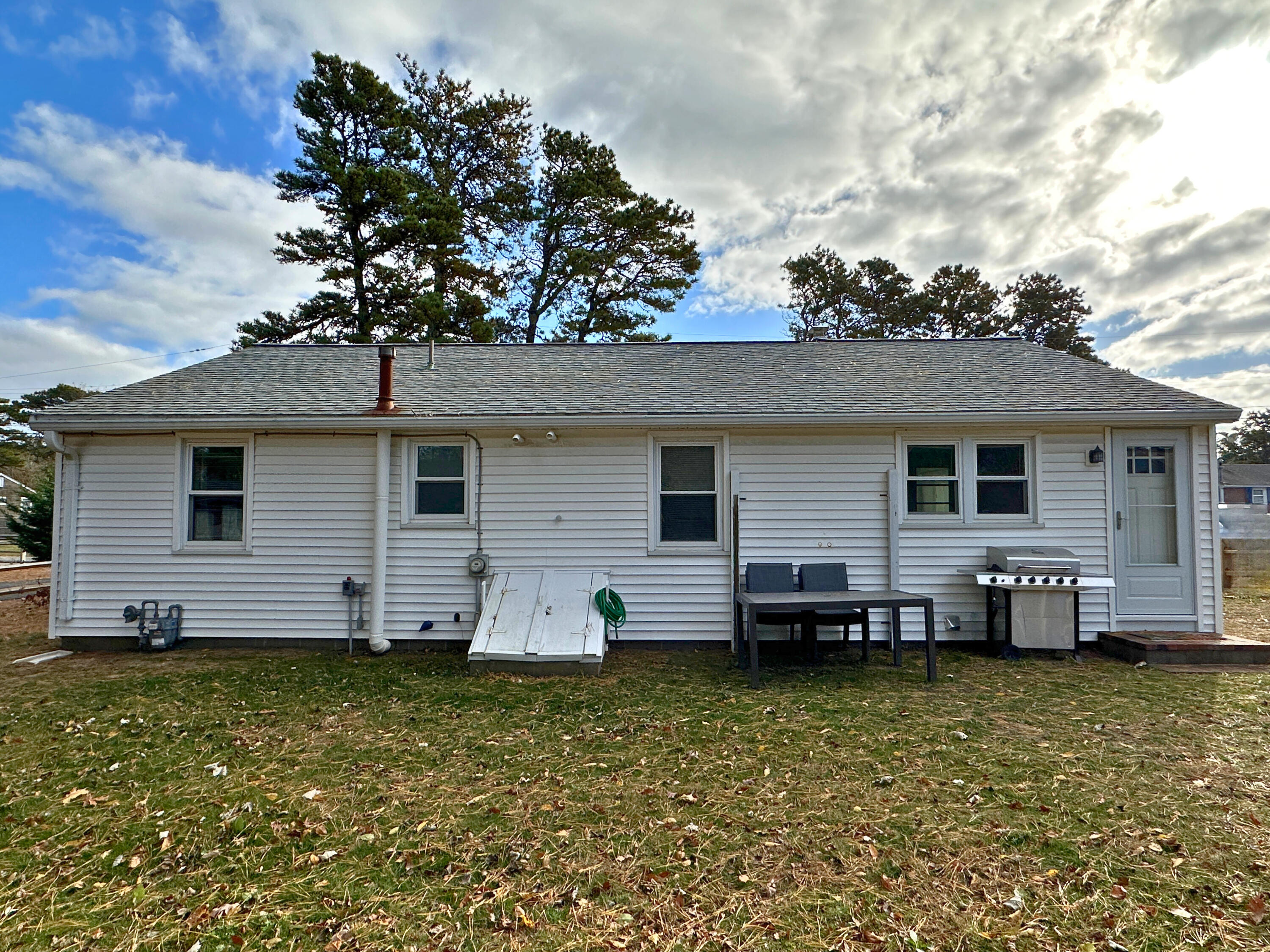 27 Wixon Road Dennis Port, MA 02639 - Photo 7 of 29 a view of a house with a backyard