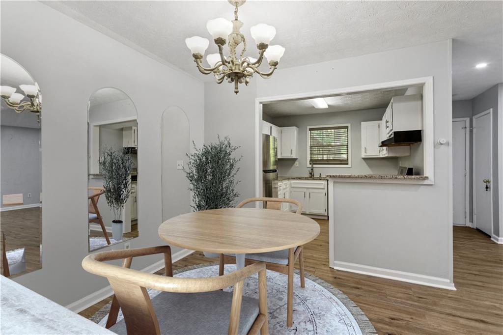 1308 Natchez Trace Atlanta, GA 30350 - Photo 11 of 27 a view of a dining room with furniture and wooden floor