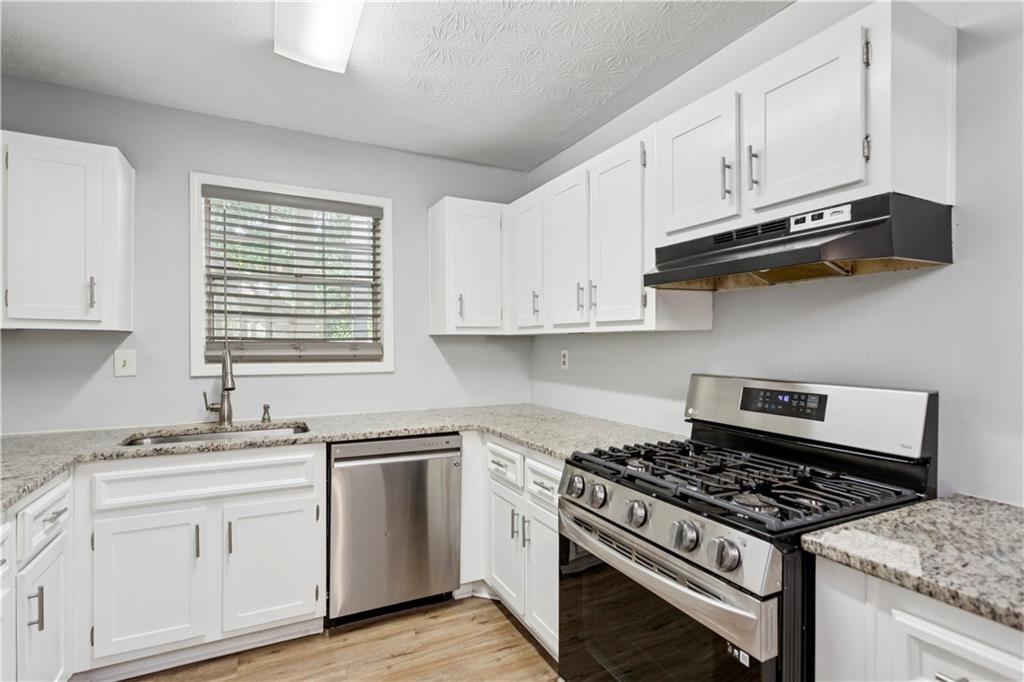 1308 Natchez Trace Atlanta, GA 30350 - Photo 13 of 27 a white kitchen with sink and stove