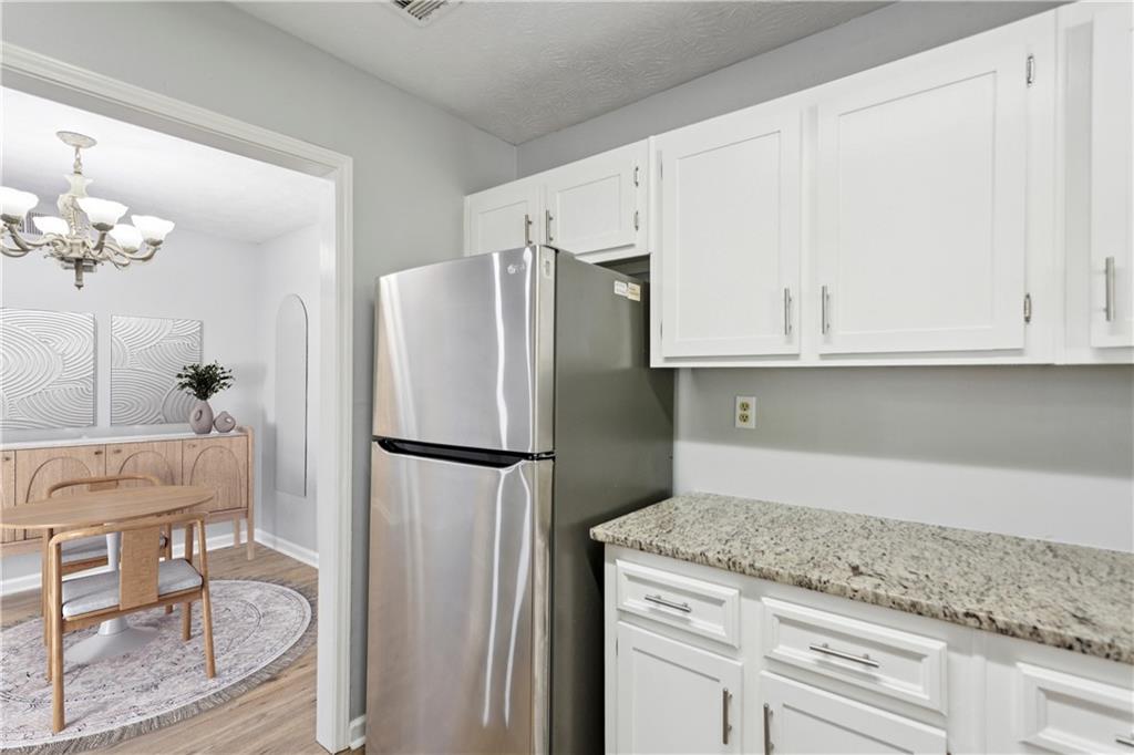 1308 Natchez Trace Atlanta, GA 30350 - Photo 14 of 27 a kitchen with stainless steel appliances granite countertop a refrigerator sink and cabinets