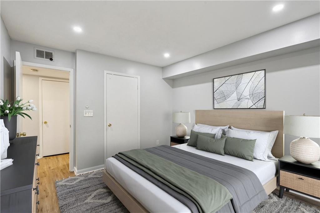 1308 Natchez Trace Atlanta, GA 30350 - Photo 20 of 27 a bedroom with a bed and a potted plant