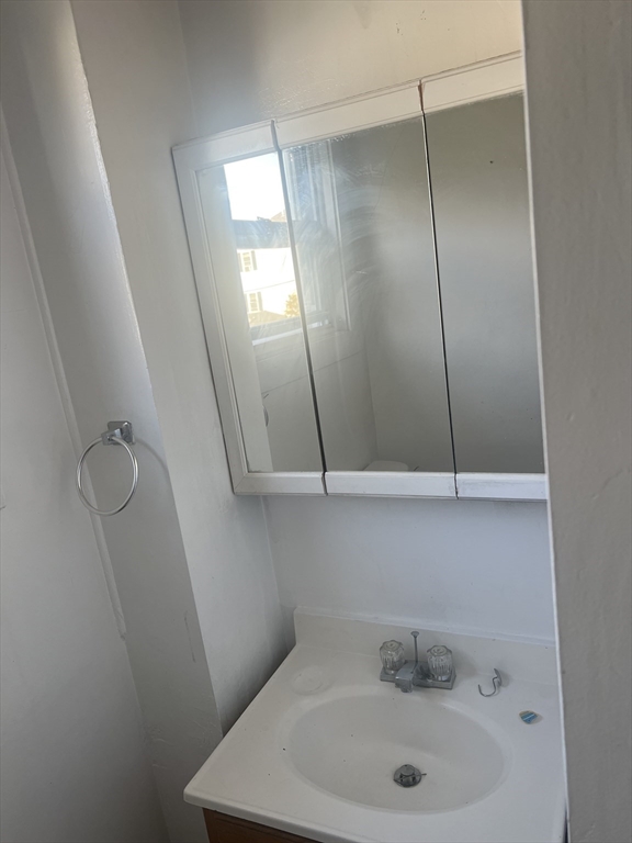 1241 North High Street, Unit 2 Fall River, MA 02720 - Photo 12 of 12 a bathroom with a sink and mirror