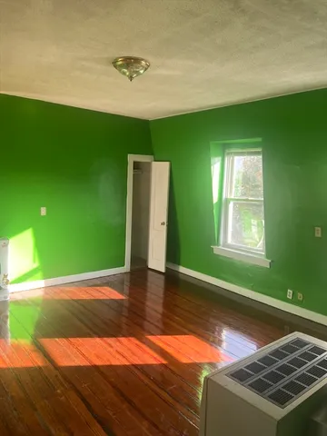 a view of a room with window wooden floor and windows