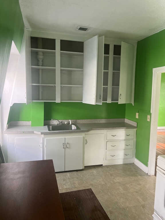 1241 North High Street, Unit 2 Fall River, MA 02720 - Photo 5 of 12 a view of cabinets and window