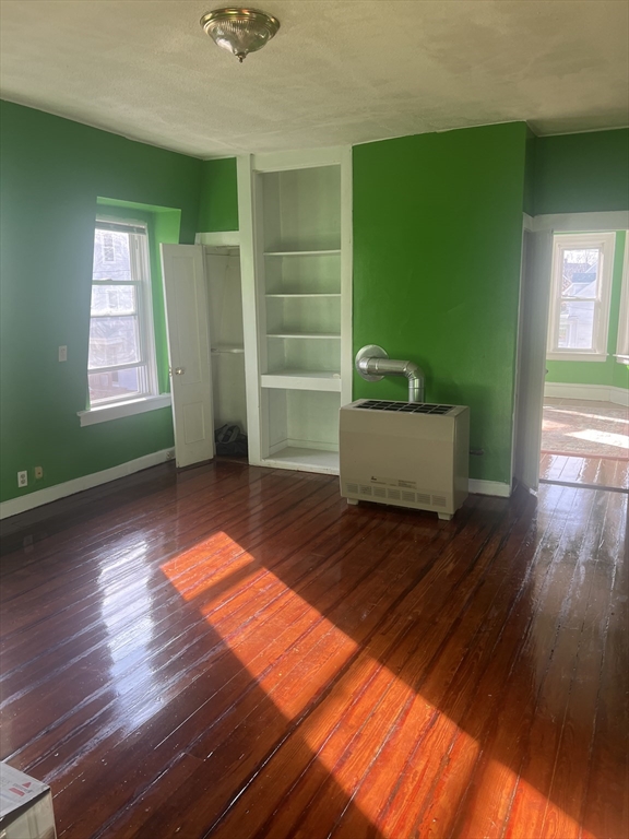 1241 North High Street, Unit 2 Fall River, MA 02720 - Photo 8 of 12 a view of empty room with stairs and wooden floor