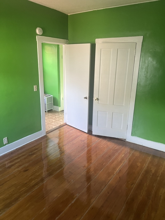 1241 North High Street, Unit 2 Fall River, MA 02720 - Photo 10 of 12 a view of an empty room with closet and wooden floor