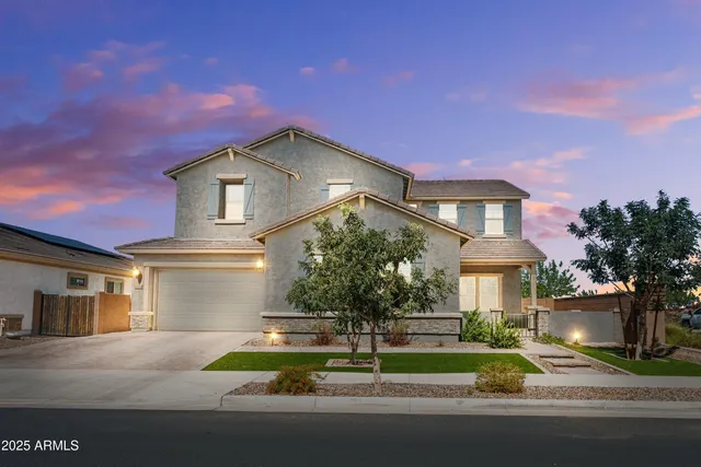 a front view of a house with a yard and garage