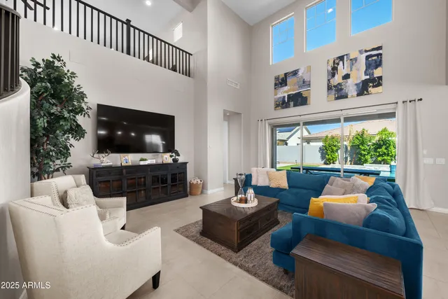 a view of a livingroom with furniture and staircase