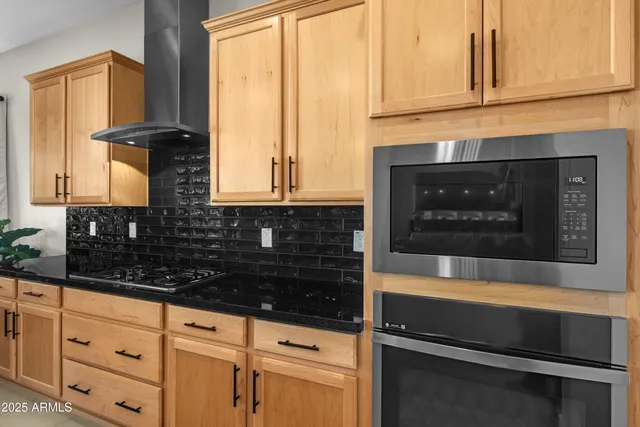 a kitchen with granite countertop a stove and a shower