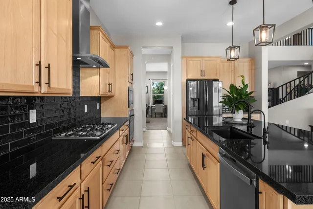 a kitchen with granite countertop white cabinets and black appliances