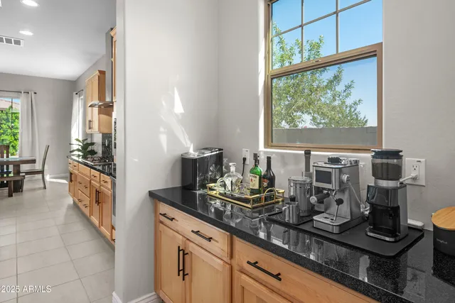 a large kitchen with stainless steel appliances granite countertop a sink a counter space and a stove