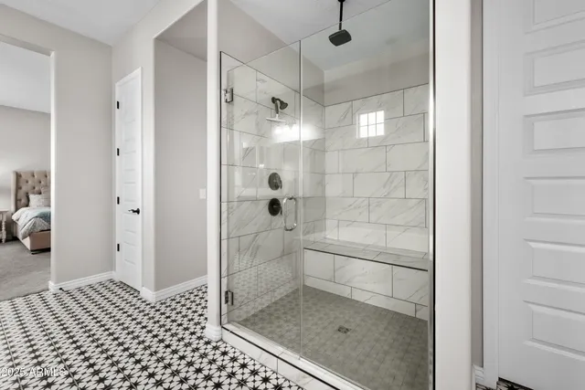 a bathroom with a sink a toilet a mirror and shower