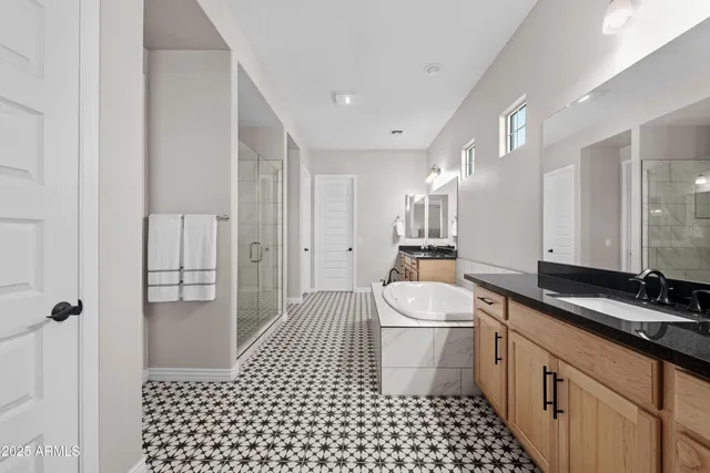 a bedroom with a bed and a chandelier fan