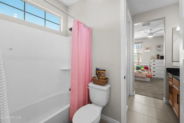 a utility room with granite countertop cabinets and washer dryer