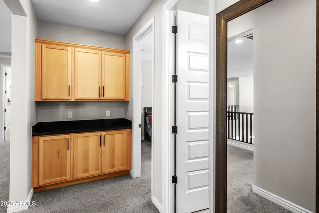 a bathroom with double vanity sinks a toilet a mirror and shower