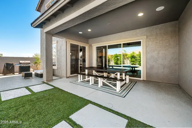 a view of a house with swimming pool and sitting area