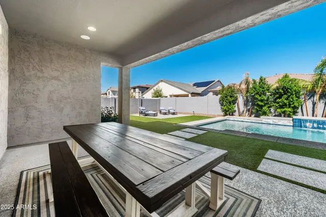 a view of a swimming pool with an outdoor seating and a garden
