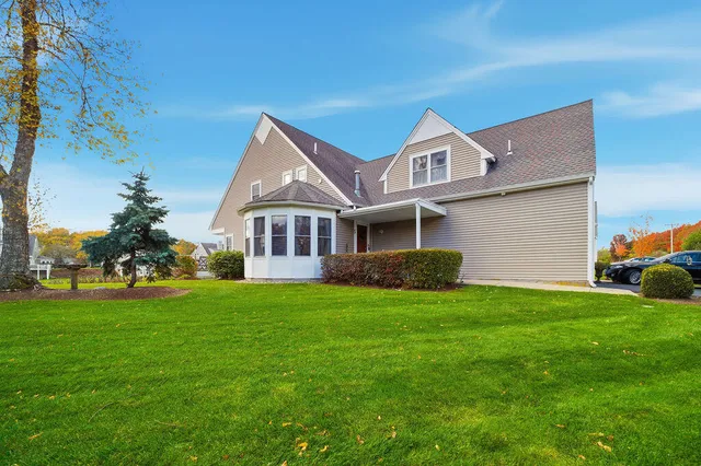 a front view of a house with a garden