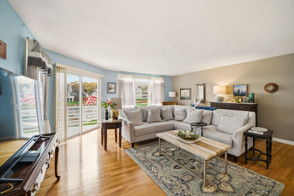69 Bay Pointe Dr Extension, Unit 69 Buzzards Bay, MA 02532 - Photo 13 of 44 a living room with furniture and a wooden floor