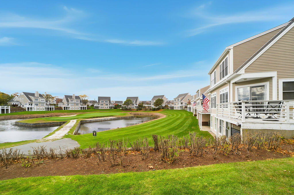 69 Bay Pointe Dr Extension, Unit 69 Buzzards Bay, MA 02532 - Photo 16 of 44 a view of a house with swimming pool and yard