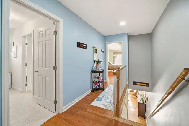 a view of a hallway with a livingroom and furniture