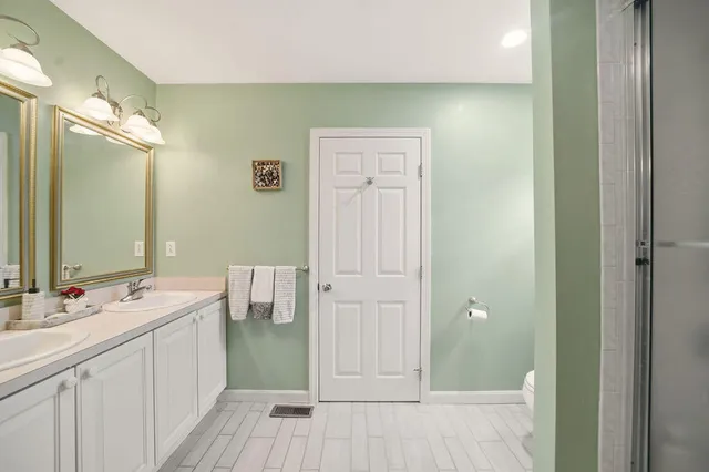 a bathroom with a double vanity sink and a mirror