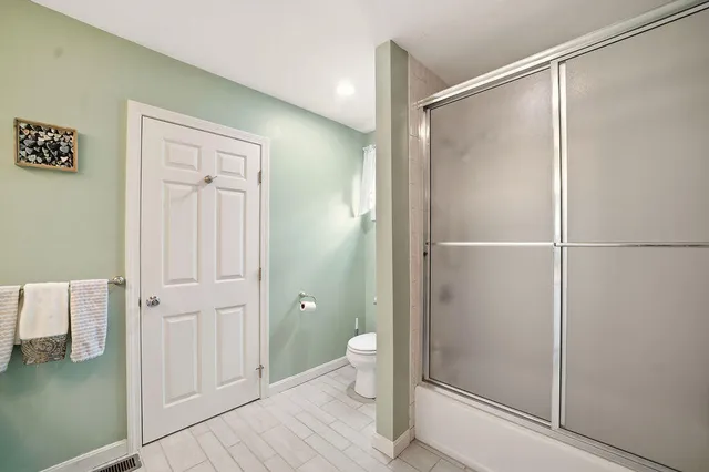 a bathroom with a shower and a toilet