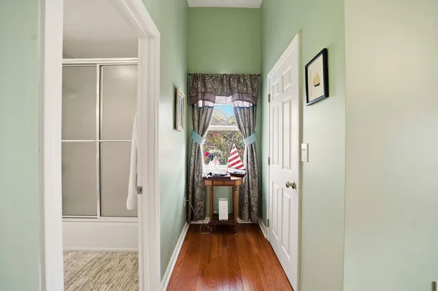 a view of a hallway view with wooden floor and staircase